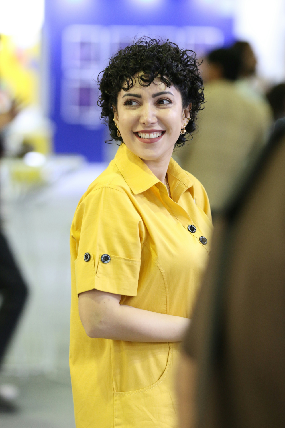 Woman in yellow shirt smiling